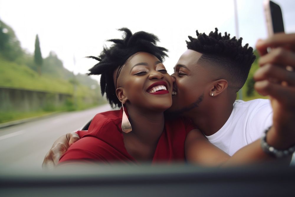 Laughing black couple making selfie on the back seat of convertible car portrait laughing travel. AI generated Image by…