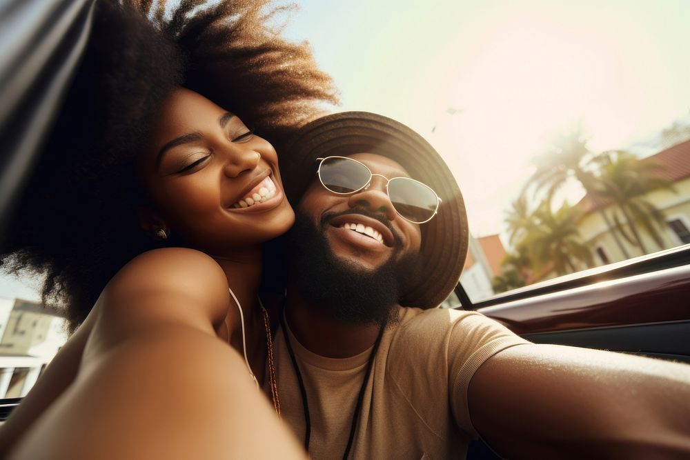 Laughing black couple making selfie on the back seat of convertible car laughing portrait travel. AI generated Image by…