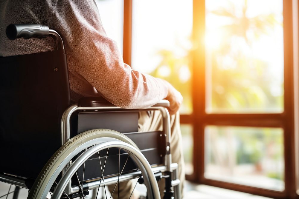 Paraplegic patient sitting in wheelchair receiving care architecture parasports furniture. AI generated Image by rawpixel.
