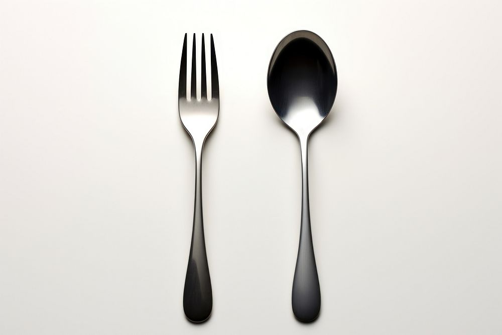 A spoon and fork white background silverware simplicity. AI generated Image by rawpixel.
