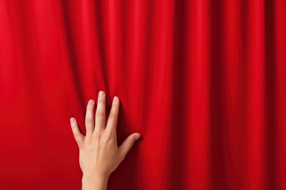 Hand opening a red curtain on stage backgrounds gesturing touching. AI generated Image by rawpixel.