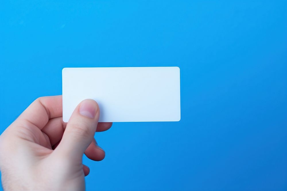 White business card hand blue electronics. AI generated Image by rawpixel.