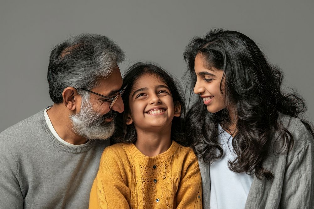 Indian family laughing looking glasses. 