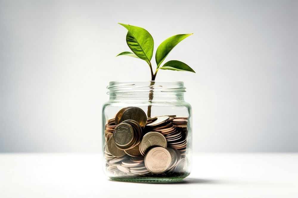 Green little plant in jar full of coins money investment currency. AI generated Image by rawpixel.