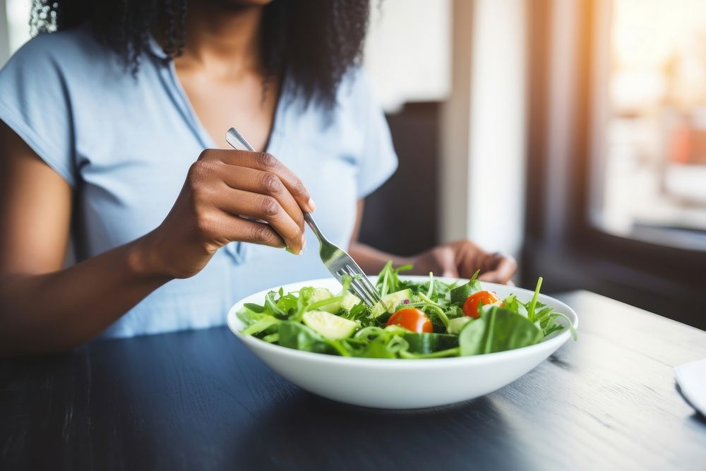 Woman eating salad table food restaurant. AI generated Image by rawpixel.