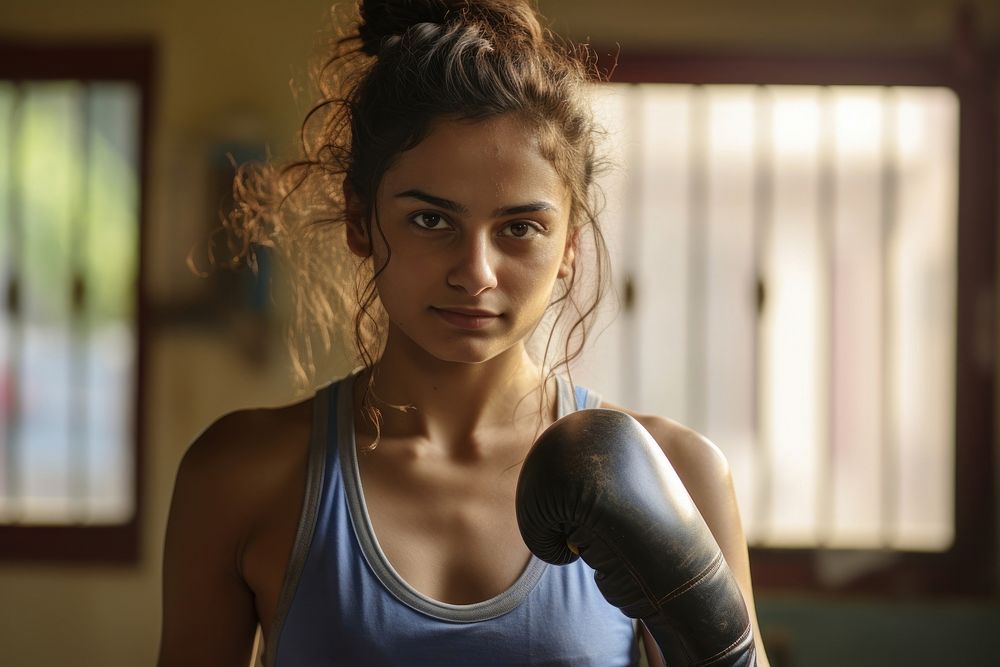 Young indian woman boxing face determination. AI generated Image by rawpixel.