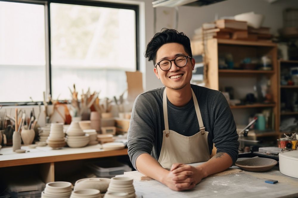 Pottery east asian man glasses studio. AI generated Image by rawpixel.