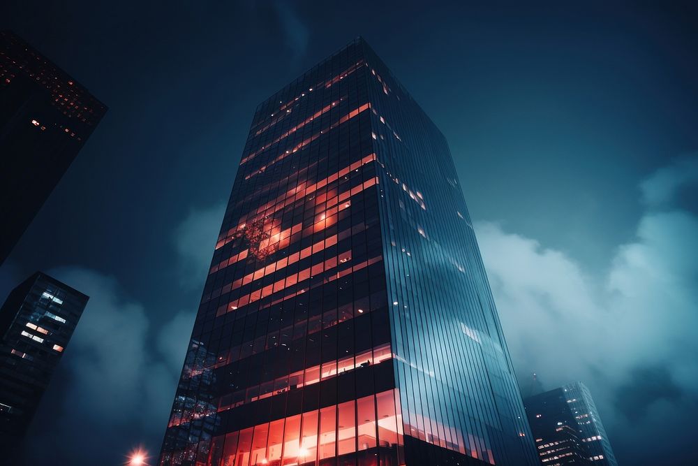Modern skyscraper architecture illuminated cityscape. AI generated Image by rawpixel.