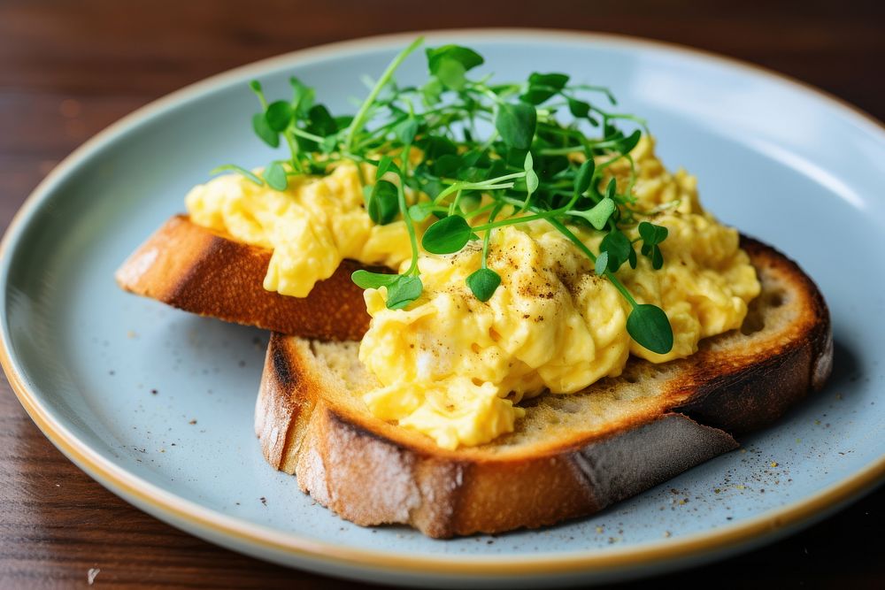 Sourdough toast scrambled eggs plate food. AI generated Image by rawpixel.