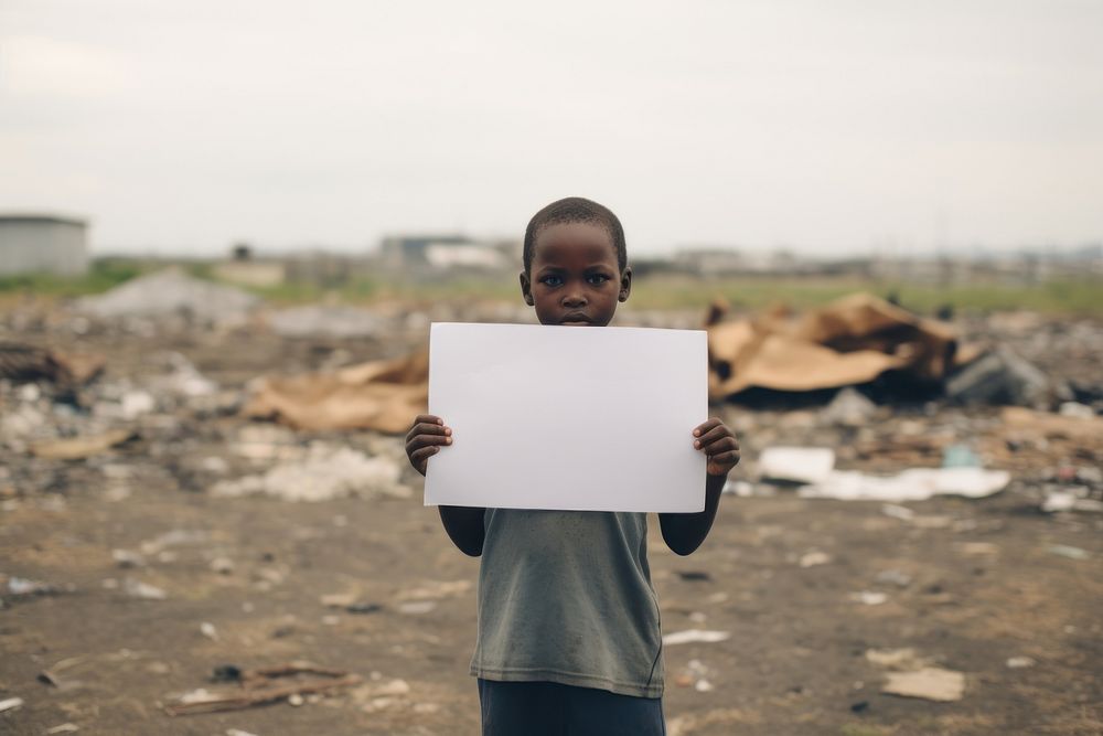 Boy holding a blank sign child homelessness architecture. AI generated Image by rawpixel.