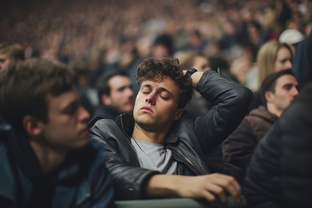 Male in crowd of fans feeling sleepy audience worried adult. AI generated Image by rawpixel.