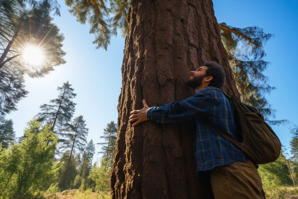 Man hugging a big tree outdoors forest plant. AI generated Image by rawpixel.