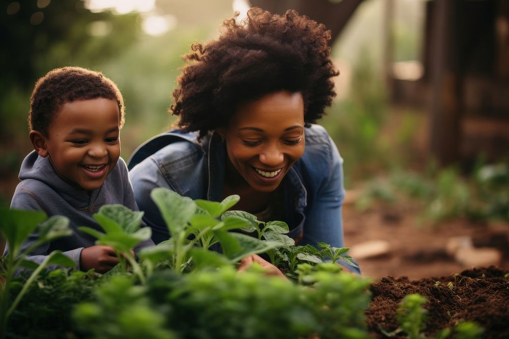 Black South African mom and son harvesting garden gardening outdoors. AI generated Image by rawpixel.
