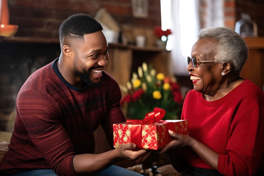 Black South African son giving a gift to his mother family adult love. AI generated Image by rawpixel.