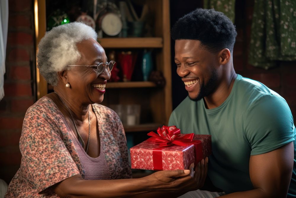 Black South African son giving a gift to his mother family adult love. AI generated Image by rawpixel.