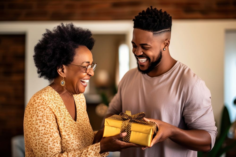 Black South African son giving a gift to his mother adult love togetherness. AI generated Image by rawpixel.