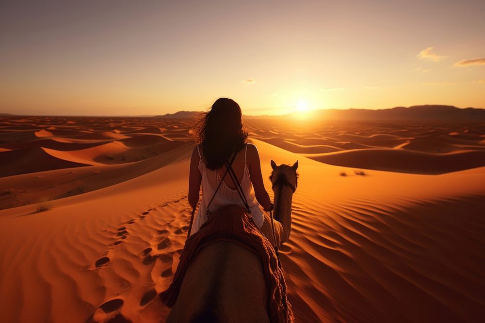African Woman riding Camels in sand dunes outdoors nature desert. AI generated Image by rawpixel.