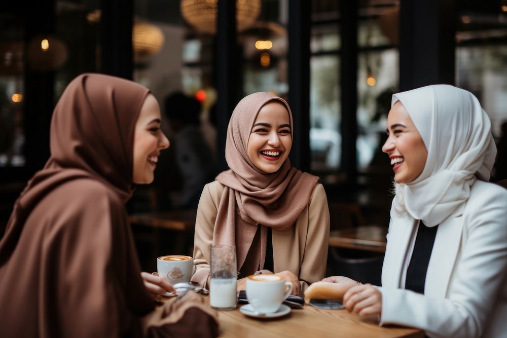 Women in hijab laughing at a coffee shop scarf adult togetherness. AI generated Image by rawpixel.