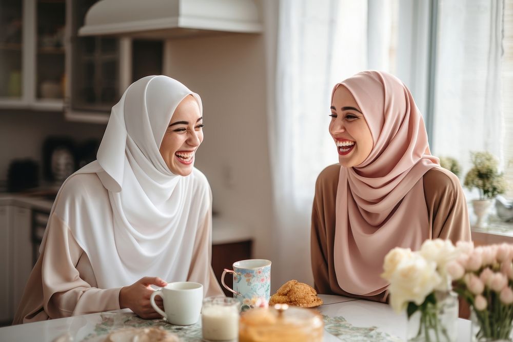 Women in hijab laughing at a kitchen togetherness celebration friendship. AI generated Image by rawpixel.