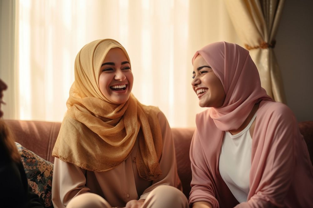 Women in hijab laughing at a living room smile adult togetherness. AI generated Image by rawpixel.