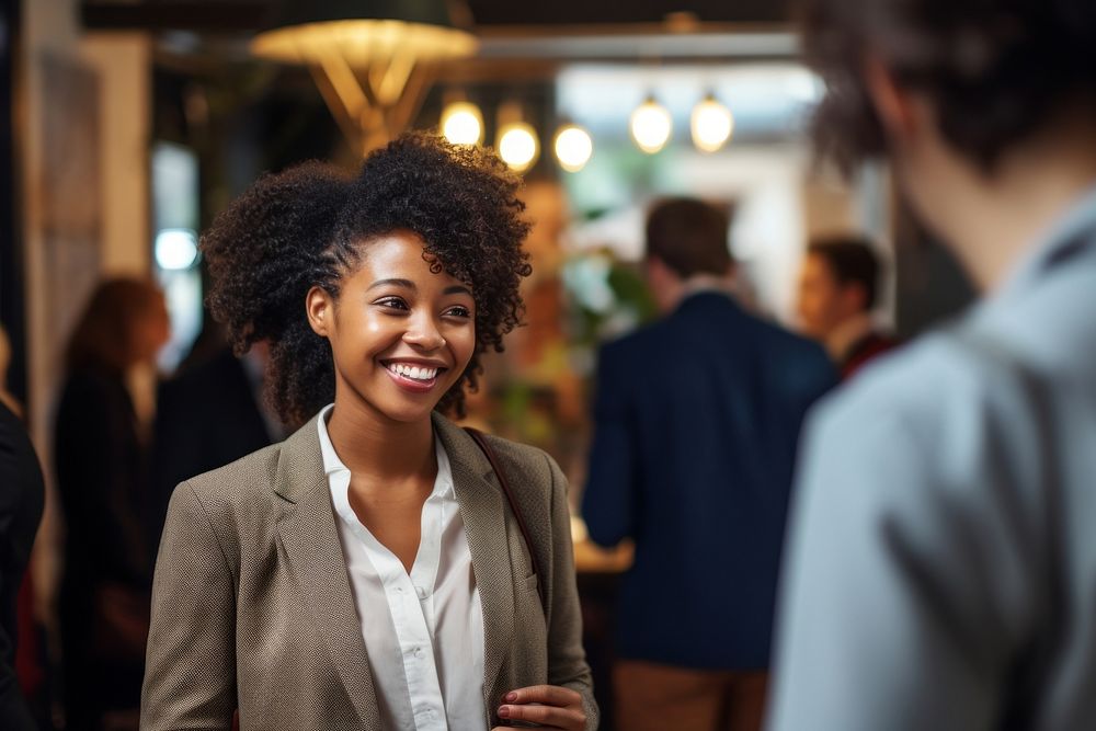 Young African woman sis standing and talking in business meeting smiling adult smile. AI generated Image by rawpixel.