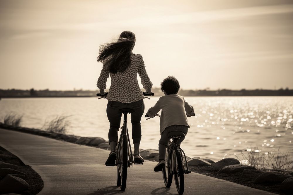 A mother and child on a bike on a riverside photography outdoors cycling. AI generated Image by rawpixel.