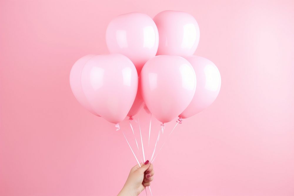 Hands hold pink hearts shaped balloons anniversary celebration birthday. AI generated Image by rawpixel.