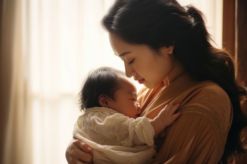 Local Asian woman looking at her baby daughter in her arms photography portrait newborn. AI generated Image by rawpixel.