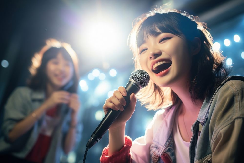 Japanese girl teenage friends karaoke entertainment microphone. AI generated Image by rawpixel.