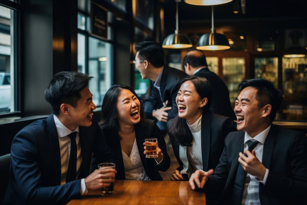 Eastern Asian business workers are laughing together adult drink beer. AI generated Image by rawpixel.