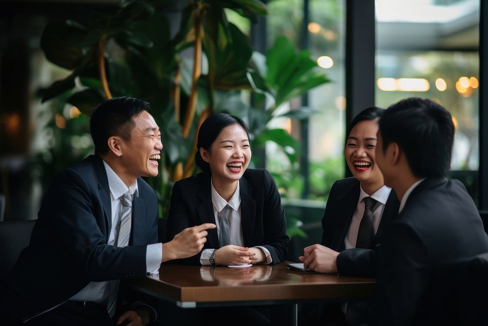 Eastern Asian business workers are laughing together meeting adult togetherness. AI generated Image by rawpixel.