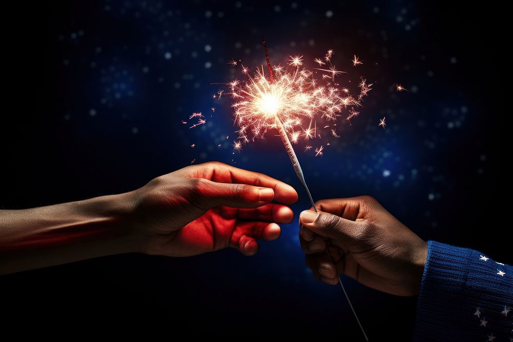 Hand hold sparkler and usa flag fireworks sparks illuminated. AI generated Image by rawpixel.