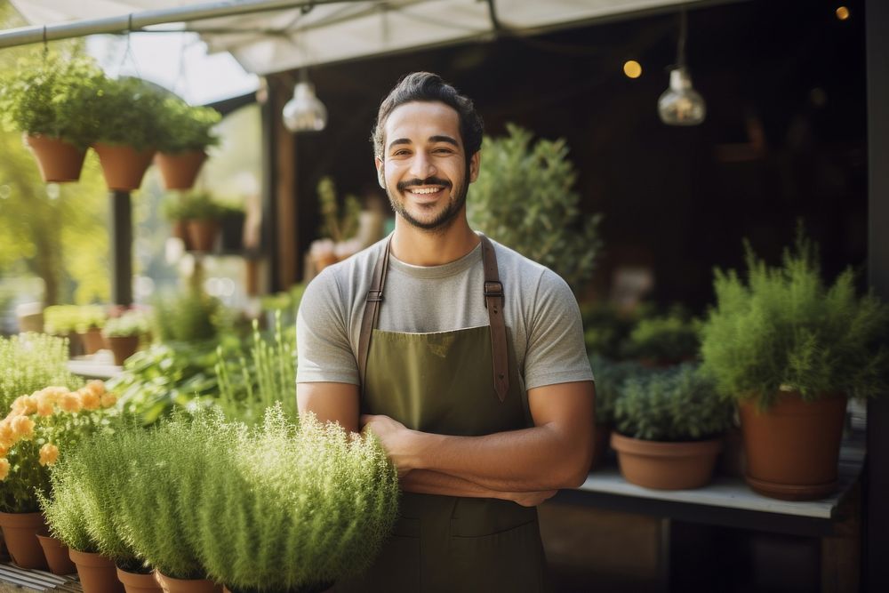 A multiracial man holding a potted plants in front of plant shop outdoors gardening working. AI generated Image by rawpixel.