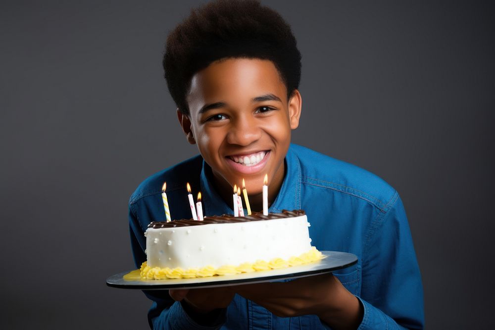 African American a boy teenage smile party cake. 