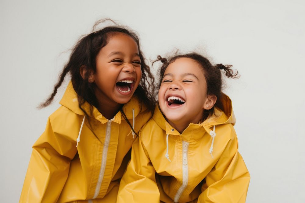 Girl in yellow raincoat laughing child face. AI generated Image by rawpixel.