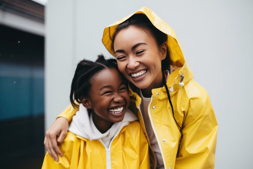 Girl in yellow raincoat laughing joy togetherness. AI generated Image by rawpixel.