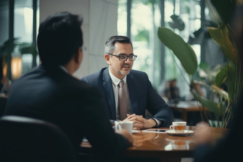 Indonesian middleage businessman conversation meeting adult. AI generated Image by rawpixel.
