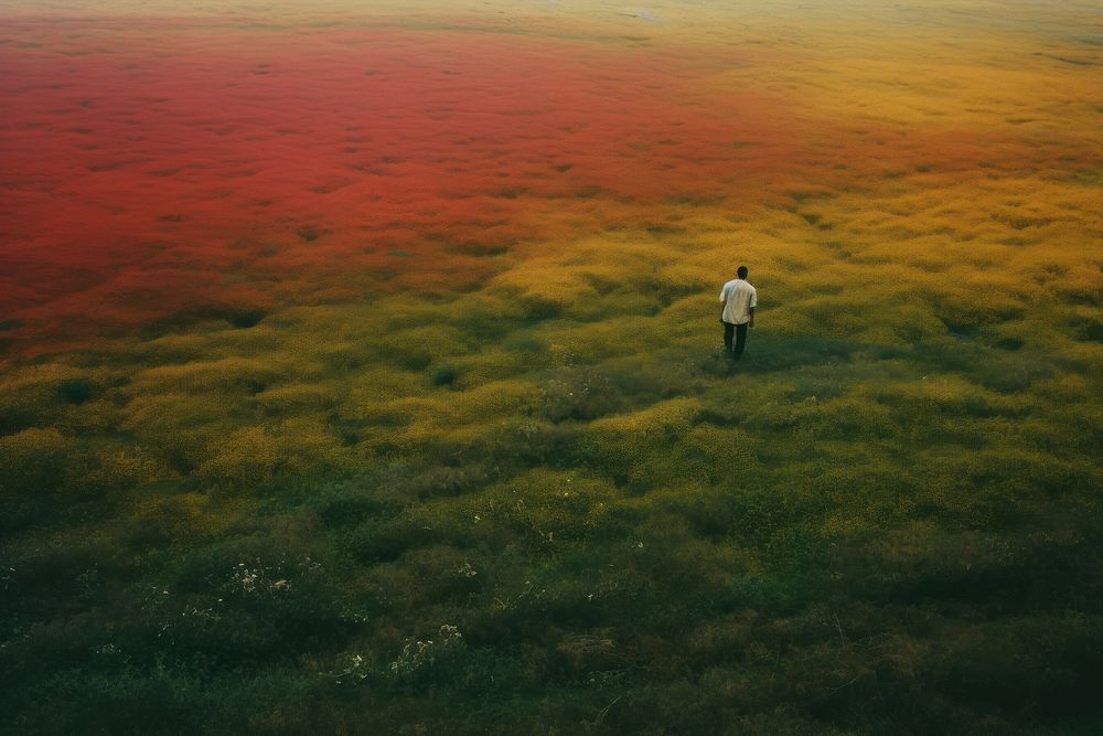 An happy affrican man standing in a minimal-large grassland landscape outdoors walking. AI generated Image by rawpixel.