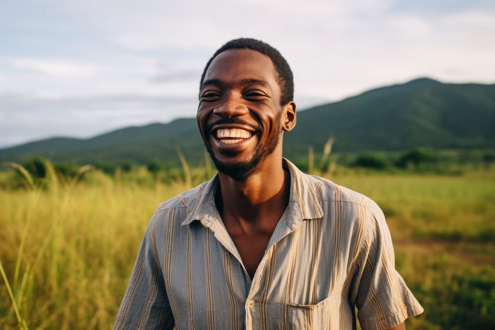 An happy affrican man portrait landscape laughing grass. AI generated Image by rawpixel.
