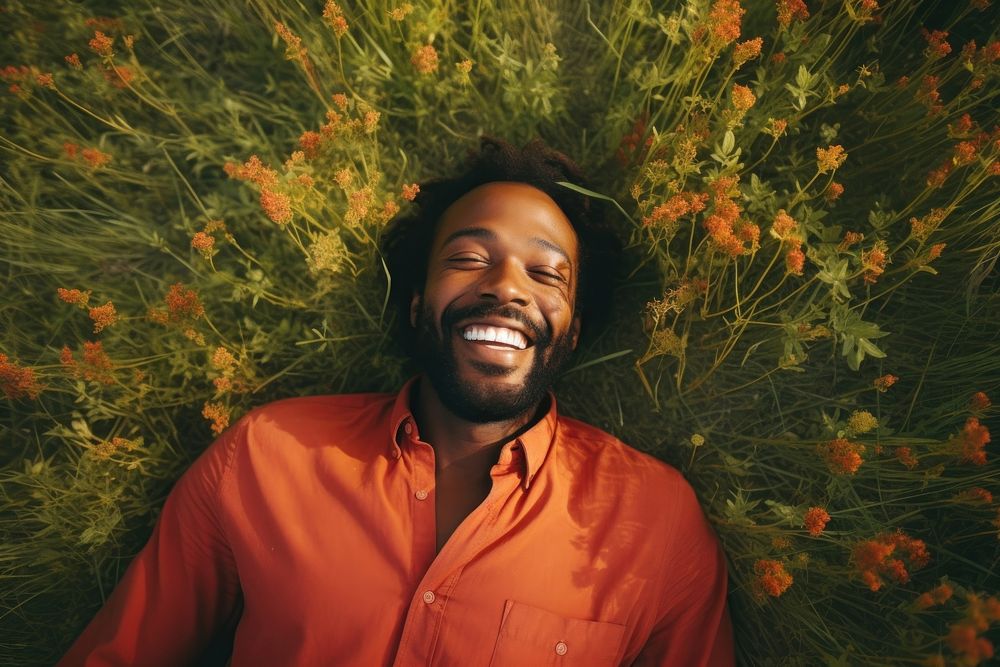 An happy affrican man looking at camera photography grassland laughing. AI generated Image by rawpixel.