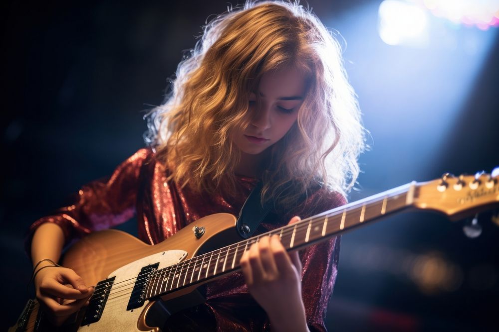 Young girl playing electreic guitar musician entertainment performance. AI generated Image by rawpixel.