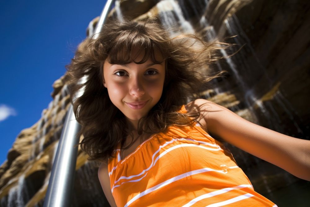 A Latina Argentinian teenage girl having an extremely fun time at a waterfall portrait outdoors summer. AI generated Image…