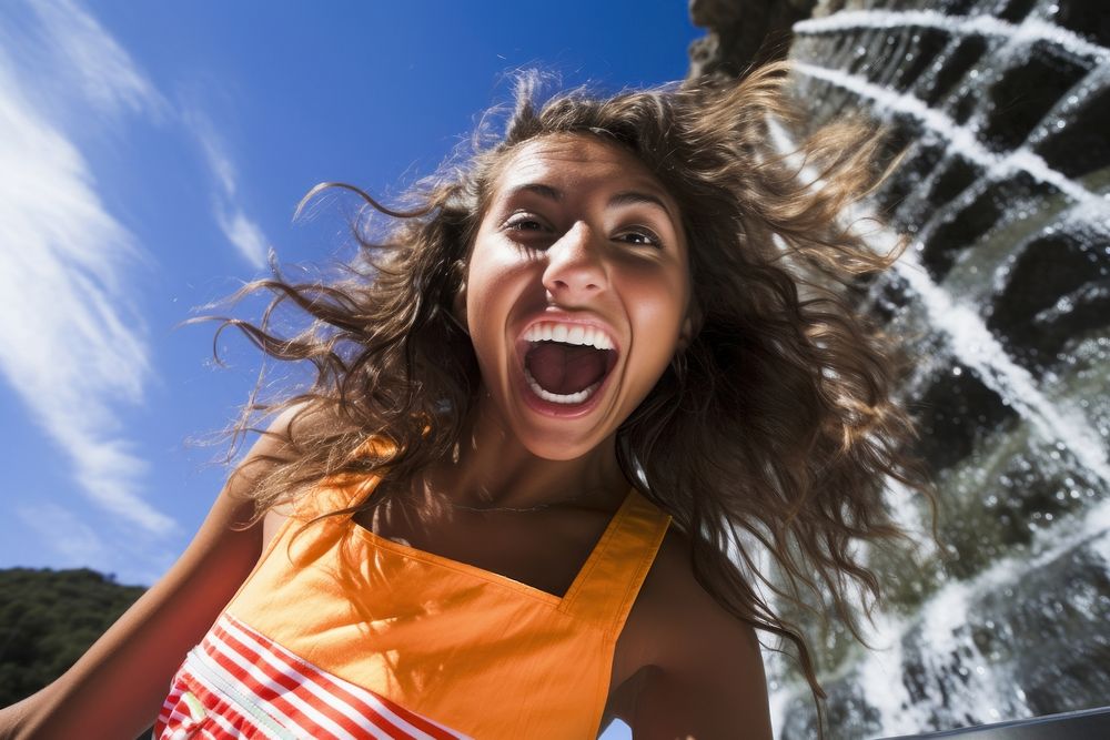 A Latina Argentinian teenage girl having an extremely fun time at a waterfall shouting laughing summer. AI generated Image…