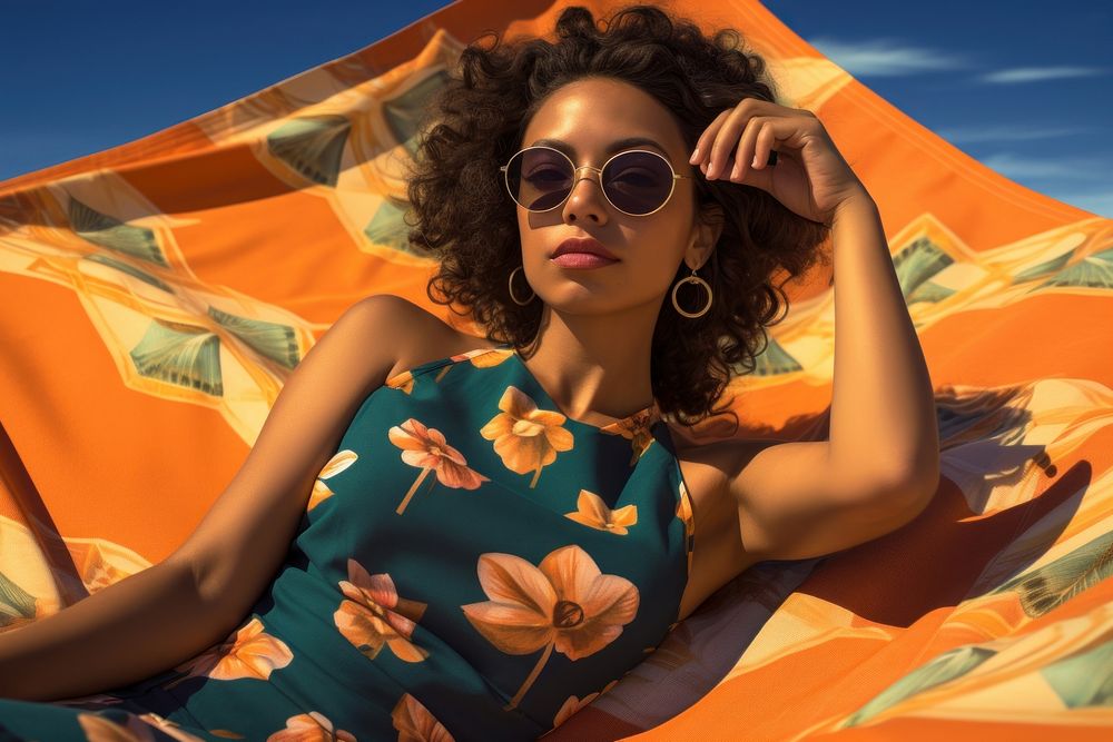 A Latina Colombian woman lounging on a large beach towel sunglasses sunbathing portrait. AI generated Image by rawpixel.