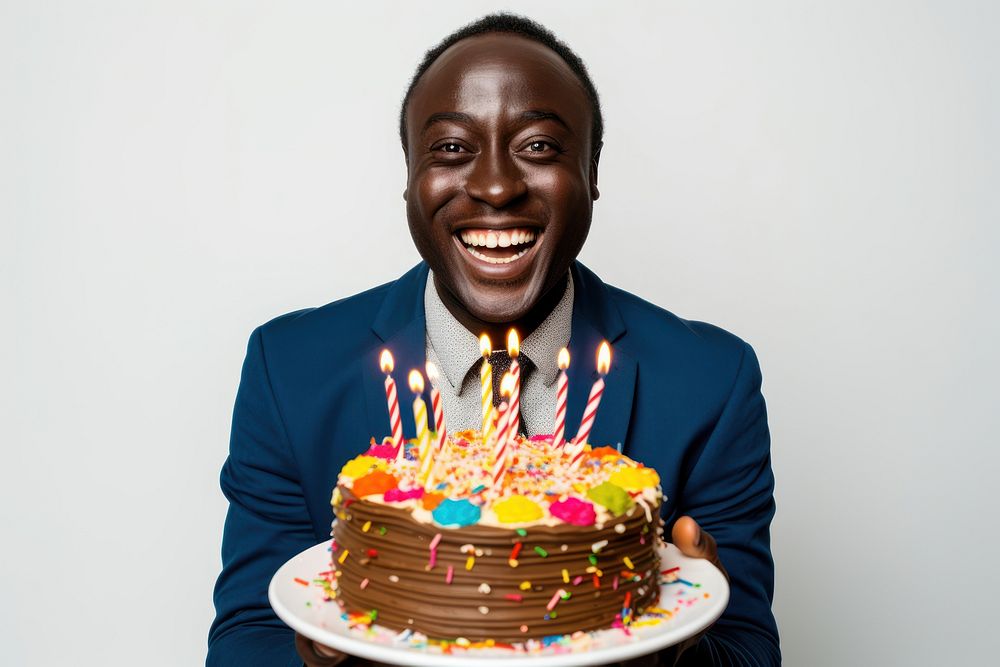 Black man holding a birthday cake dessert party food. AI generated Image by rawpixel.