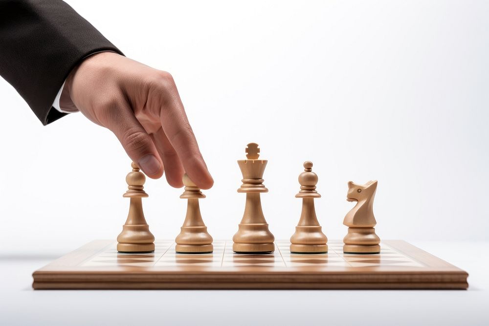 Hand playing chess game white background intelligence. AI generated Image by rawpixel.