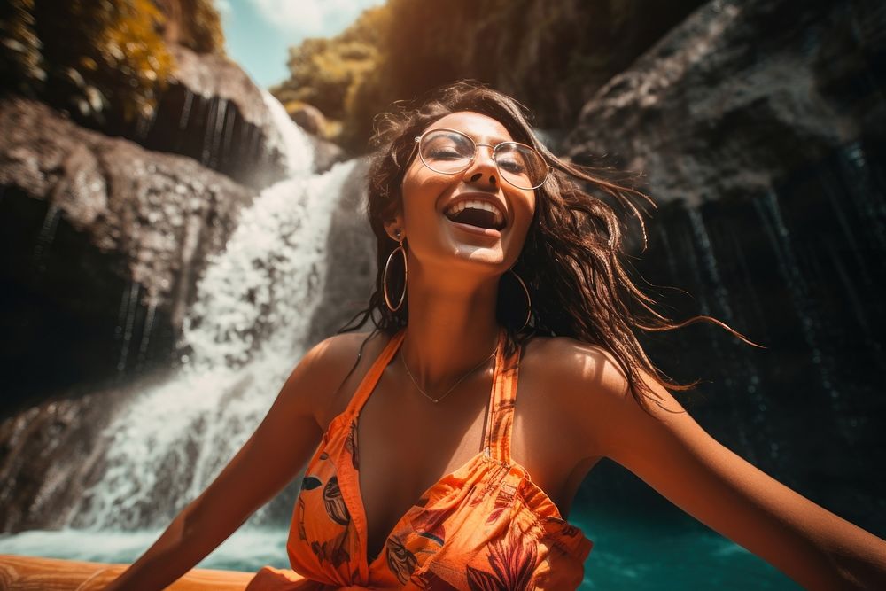 A Latina Brazilian young woman having an incredibly fun time at a tropical waterfall laughing summer smile. AI generated…