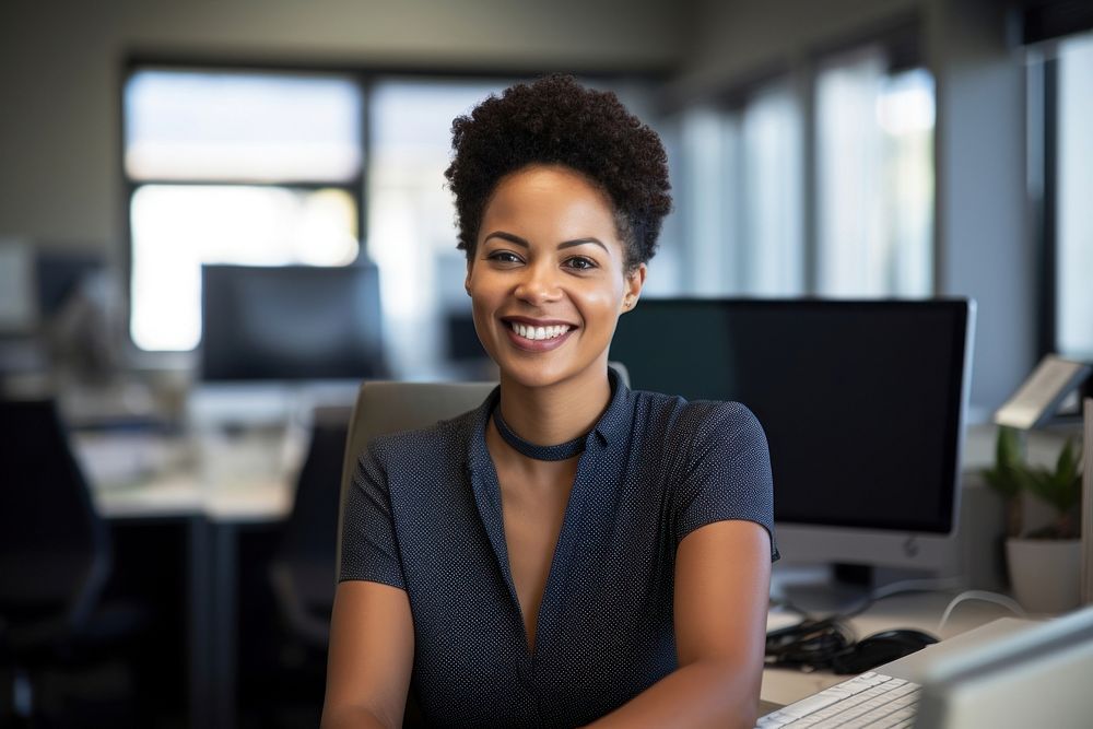 South African businesswoman using a computer smiling office adult. AI generated Image by rawpixel.