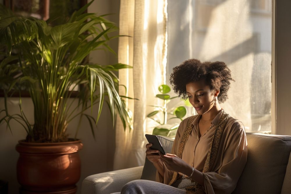 Ethiopian woman texting on her smartphone sitting adult plant. AI generated Image by rawpixel.