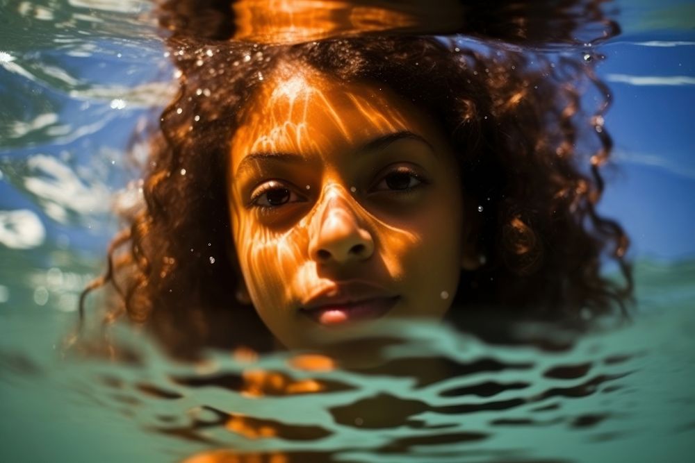 A Latina Brazilian teenage girl enjoying her time swimming underwater portrait outdoors adult. AI generated Image by…